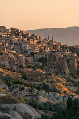Obraz premium Small town on hill in Capadocia in a morning sunrise, central Anatolia region in summer season, Turkey