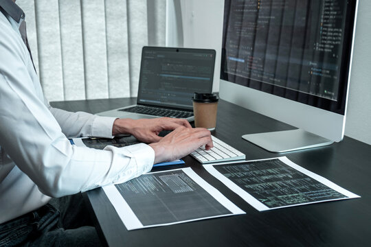 Young Programmer working in software javascript computer in IT office, Writing codes and data code website and coding database technologies to find solution to problem