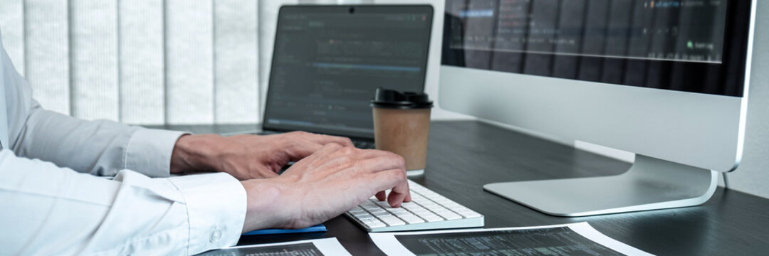 Young Programmer working in software javascript computer in IT office, Writing codes and data code website and coding database technologies to find solution to problem