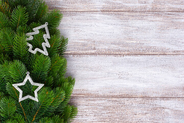 mock up, silver decorations on Christmas tree branches on a wooden background.