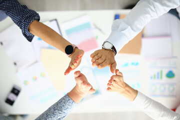 Business people over the work table are greeting hands. Successful business ideas and agreements...