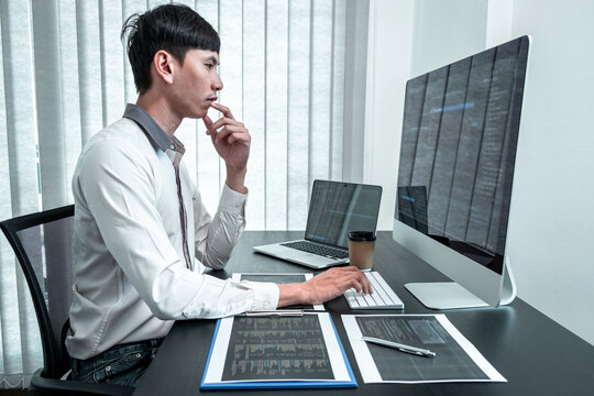 Young Programmer working in software javascript computer in IT office, Writing codes and data code website and coding database technologies to find solution to problem