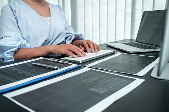 Female Programmer working in software javascript computer in IT office, Writing codes and data code website and coding database technologies to find solution to problem