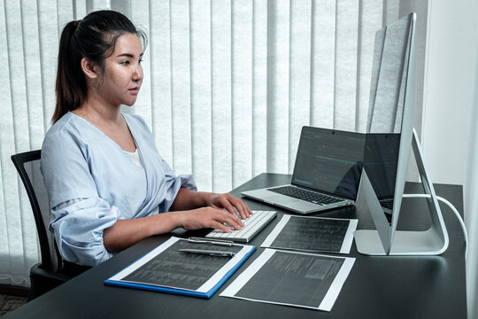 Female Programmer working in software javascript computer in IT office, Writing codes and data code website and coding database technologies to find solution to problem