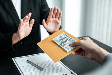 Business woman refusing receive bribe money in the envelope of their partner to give success the...