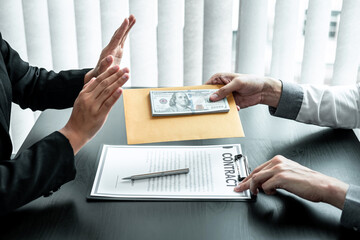 Business woman refusing receive bribe money in the envelope of their partner to give success the...