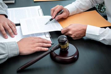 Male lawyer discussing negotiation legal case with client meeting with document contact in...