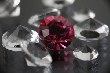 On black background there are transparent gemstones transparent and burgundy. Selling gemstones...