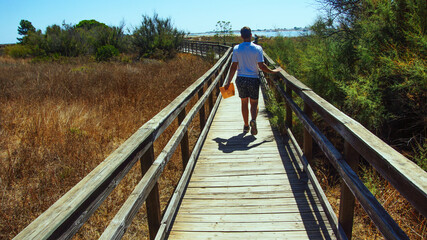 Young Man walking to the beach 