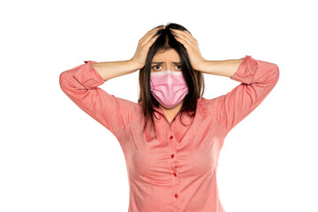 Woman with a mask unhappy holding her head, isolated on white.