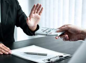 Business woman refusing receive bribe money in the envelope of their partner to give success the...
