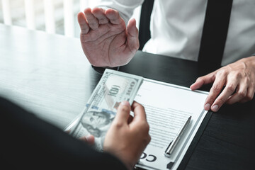 Businessman refusing receive bribe money in the envelope of their partner to give success the deal...