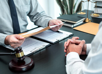 Male lawyer discussing negotiation legal case with client meeting with document contact in...