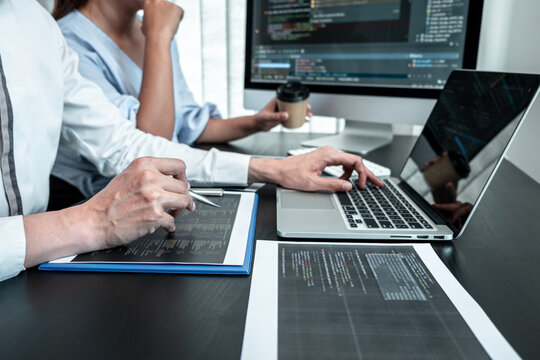 Team of Programmer working in software javascript computer in IT office, Writing codes and data code website and coding database technologies to find solution to problem