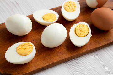 Hard Boiled Eggs on a rustic wooden board, low angle view. Close-up.