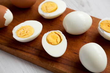 Hard Boiled Eggs on a rustic wooden board, side view. Close-up.