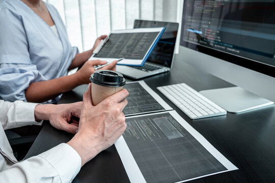 Team of Programmer working in software javascript computer in IT office, Writing codes and data code website and coding database technologies to find solution to problem