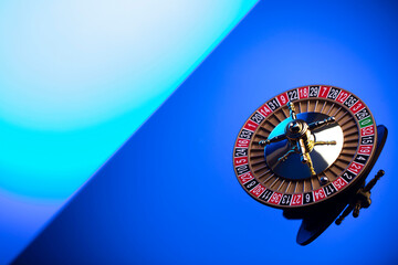 Casino theme, close up of roulette, red and black numbers. Blue background.