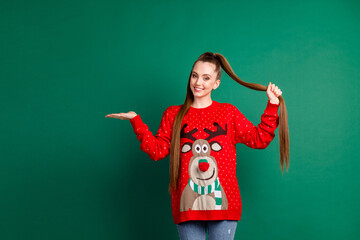 Portrait of her she nice-looking attractive pretty cheerful cheery long-haired girl holding on palm copy space choose choice gift present surprise ad isolated green color background