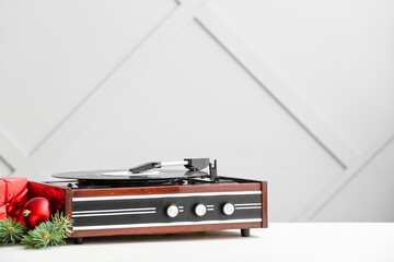 Record player and Christmas decor on table