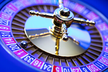 Casino theme, close up of roulette, red and black numbers. Blue background.