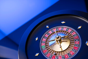Casino theme, close up of roulette, red and black numbers. Blue background.