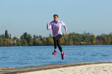 On the go. Young female athlete, woman training, practicing outdoors in autumn sunshine. Beautiful caucasian sportswoman running open-air. Concept of sport, healthy lifestyle, movement, activity.