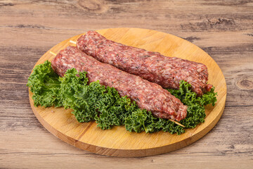 Raw minced beef kebab skewer