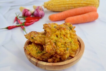 Indonesian corn fritters or Bakwan Jagung served with red chilies