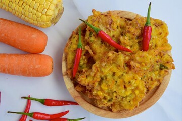 Indonesian corn fritters or Bakwan Jagung served with red chilies