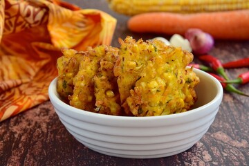 Indonesian corn fritters or Bakwan Jagung served with red chilies