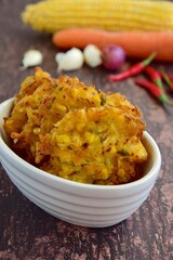 Indonesian corn fritters or Bakwan Jagung served with red chilies