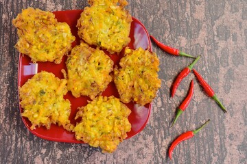 Indonesian corn fritters or Bakwan Jagung served with red chilies