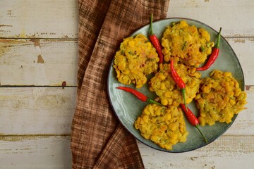 Indonesian corn fritters or Bakwan Jagung served with red chilies