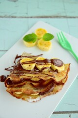 Crepes with chocolate and banana garnish with mint leaf