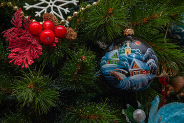 Fototapeta na wymiar Holiday decorations hanging on the branches of a christmas tree