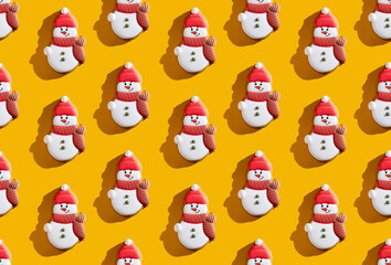 Orange Xmas background. Snowman seamless pattern. Winter holidays decoration. Cute fun white red minimalist festive design for kids isolated on bright yellow.