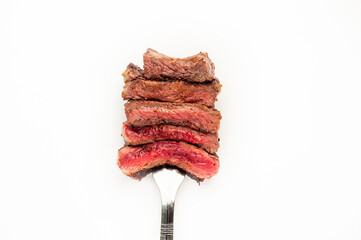 
Different degrees of doneness of steak on a fork for meat on a white background