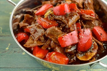 Beef black pepper steak - stir-fried tender beef with red bell peppers and mushrooms.