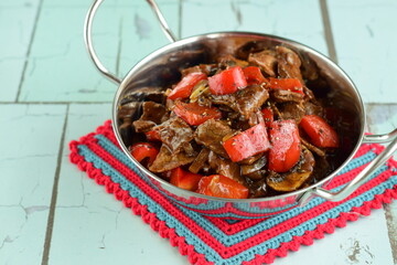 Beef black pepper steak - stir-fried tender beef with red bell peppers and mushrooms.