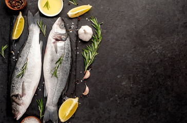 Sea bass fish with spices on a stone background  copy space for your text	