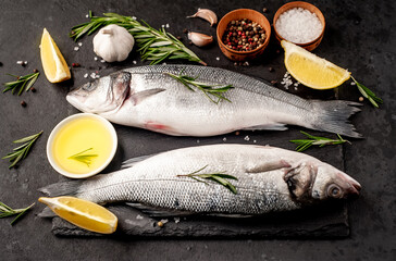Sea bass fish with spices on a stone background	