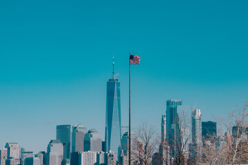 Foto de la bandera estadounidense con los rascacielos de Manhattan