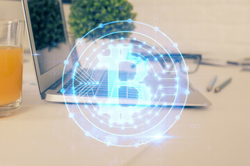 Fototapeta premium Double exposure of blockchain theme hologram and table with computer background. Concept of bitcoin crypto currency.