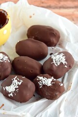 Medjool dates covered dark chocolate garnish with shredded coconut