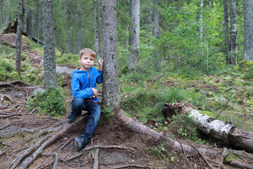Kid posing in summer forest