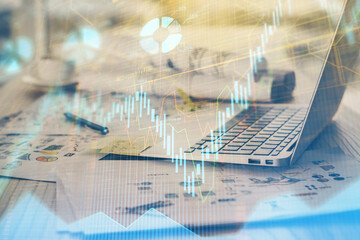 Forex market chart hologram and personal computer background. Multi exposure. Concept of investment.