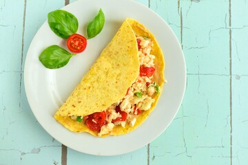 Corn tortilla filled with scrambled egg white, tomato and basil