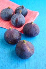 Whole fresh organic figs on blue background
