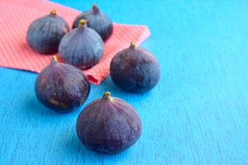 Whole fresh organic figs on blue background
